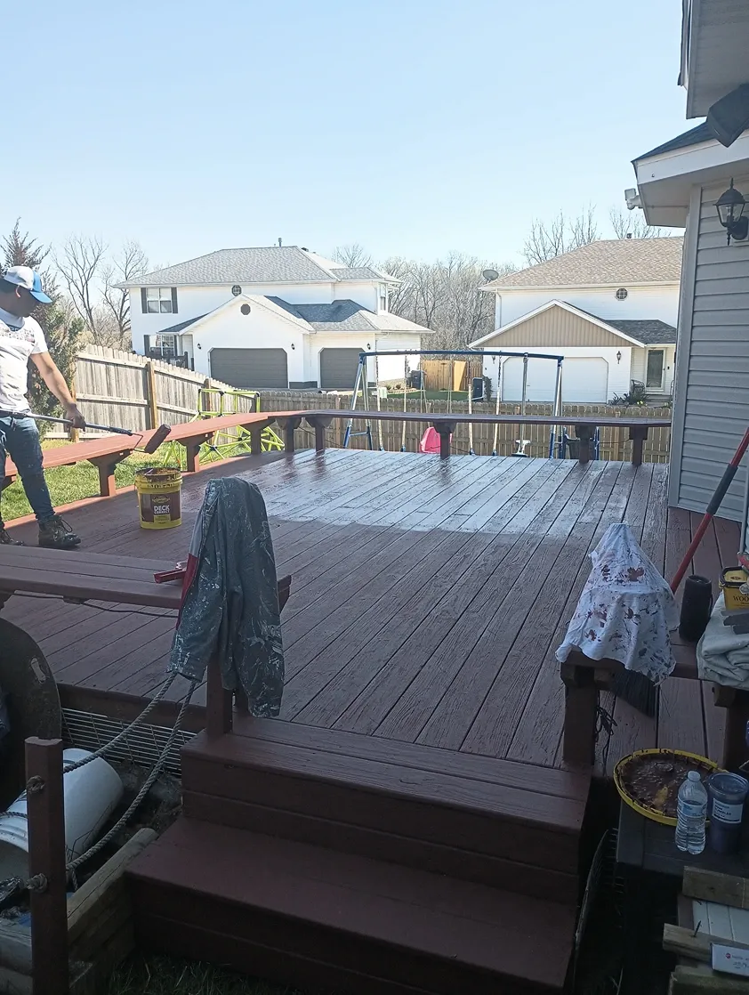 Crew staining a backyard deck